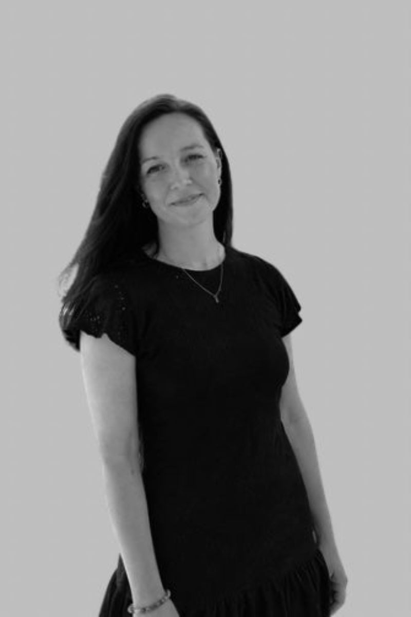 Julie Donelle wearing a black dress against a plain background