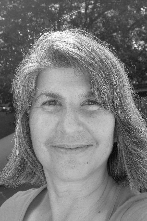 Black and white photo of a woman with light hair and a neutral expression.