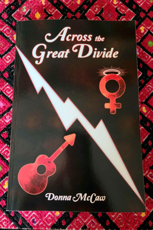 Book titled 'Across the Great Divide' by Donna McCaw on a patterned background