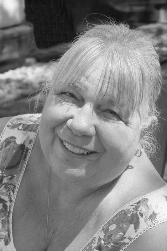 Black and white photo of a woman with a floral patterned top