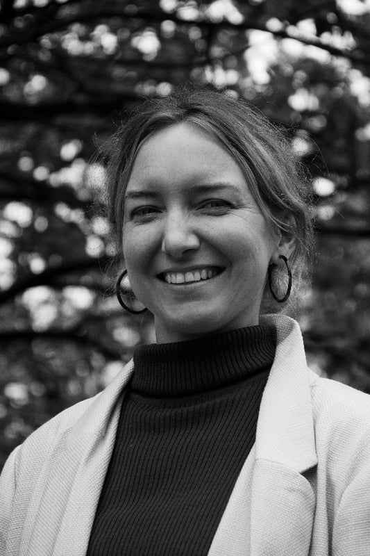 Black and white photo of a woman with a blurred natural background