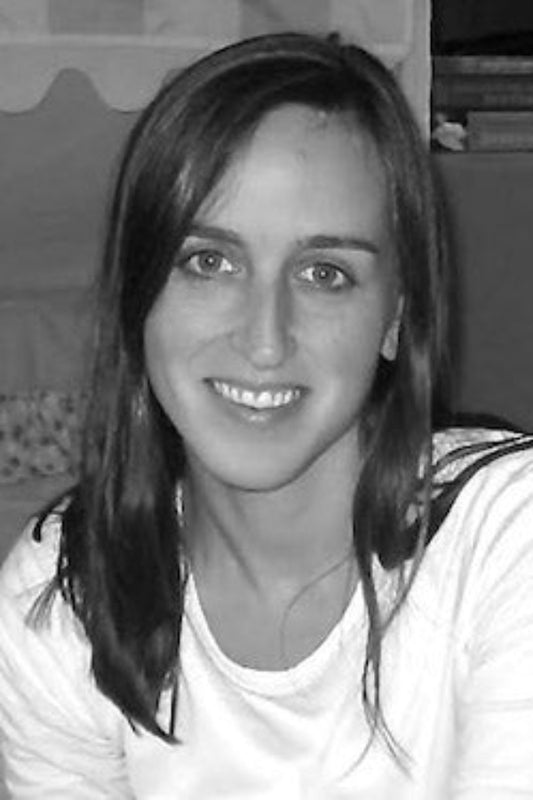 Black and white photo of a person with long hair wearing a striped shirt.