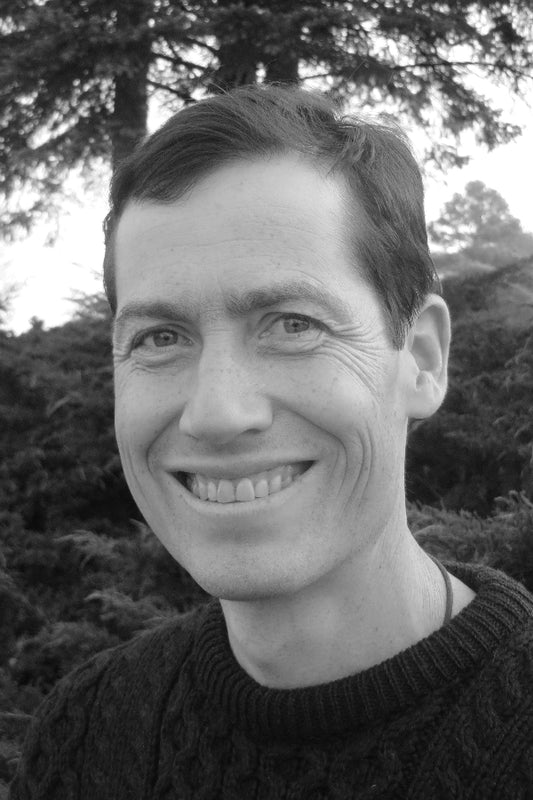 Black and white photo of a person with trees in the background