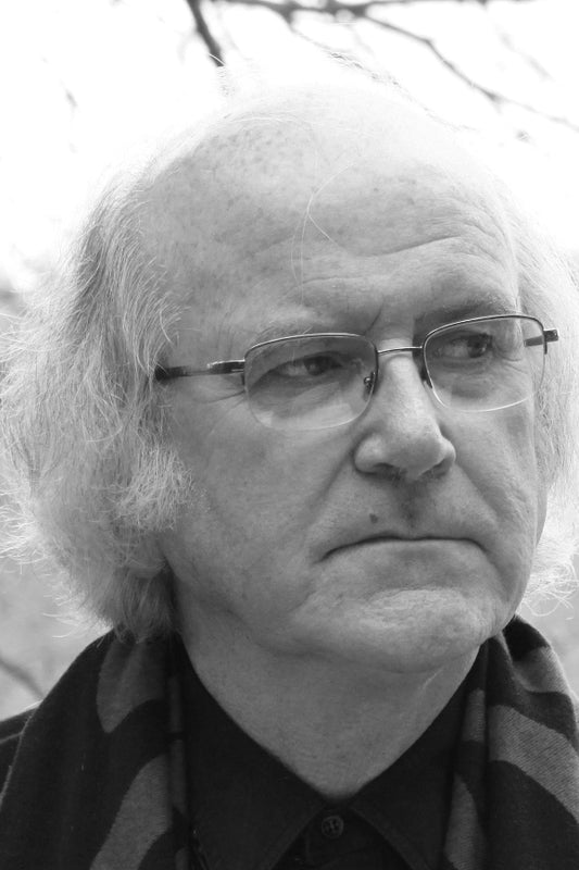 Black and white portrait of a person with glasses and a scarf