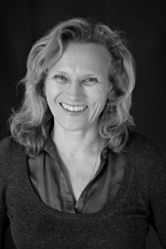 Black and white portrait of a woman with shoulder-length hair wearing a dark sweater.