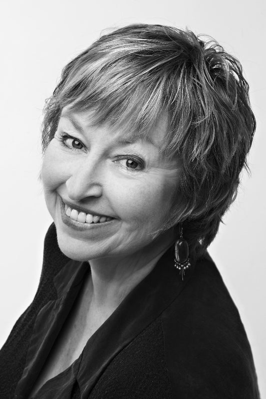 Black and white portrait of a woman with short hair and a dark top.