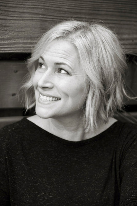 Black and white photo of a woman with short blonde hair smiling.