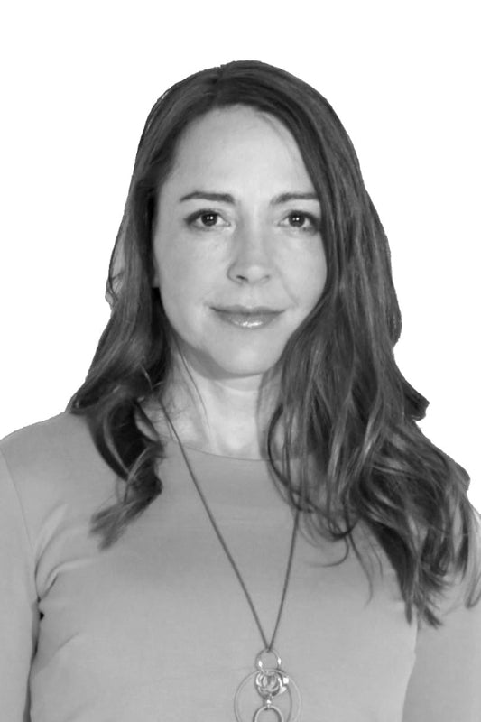 Black and white photo of a woman with long hair wearing a necklace.