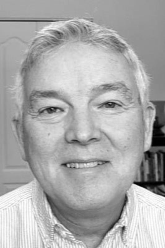 Black and white photo of a man with a neutral expression