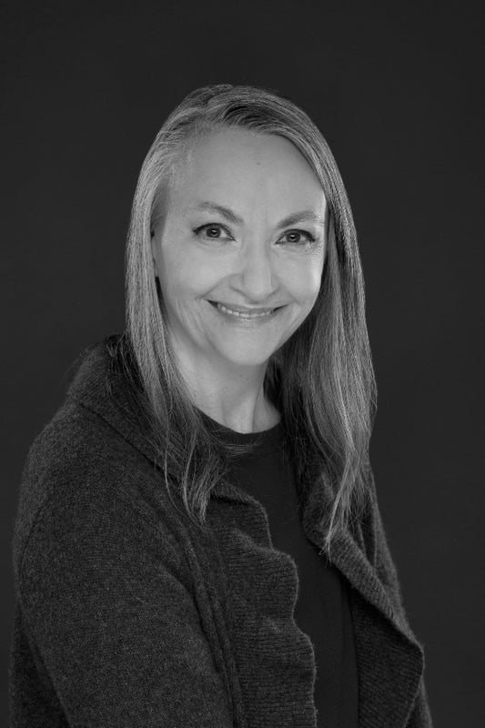 Black and white portrait of a woman with long hair against a dark background