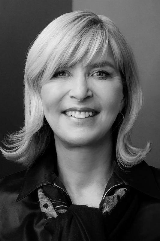 Black and white portrait of a woman with blonde hair and a dark blouse.