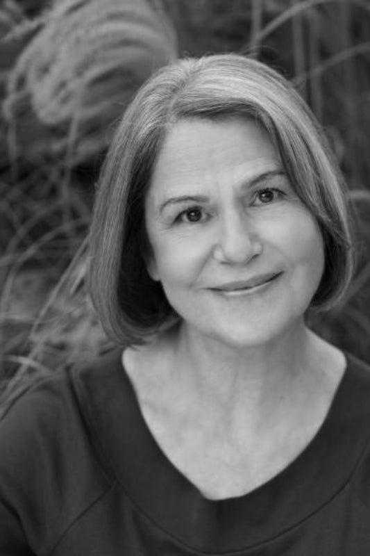 Black and white portrait of a woman with short hair against a natural background
